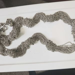 Silver looped chain belt.  Multiple small chains roped together forming a chain.